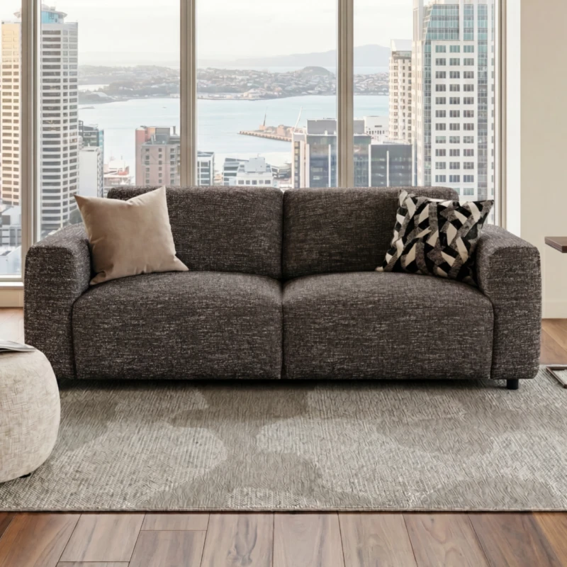 LUCA 3-Seater Sofa upholstered in Espresso fabric, paired with the DELRAY Ottoman & CAMDEN Side Table. Modern lounge setting in a Auckland city high-rise apartment.
