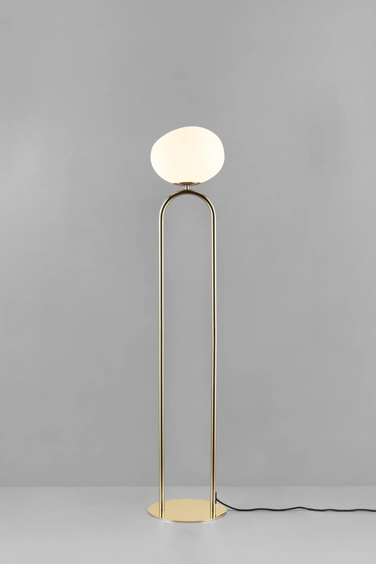 Glass and Brass Floor Lamp: Modern brass floor lamp with a white opal glass shade, minimalist and elegant design for contemporary living spaces.
