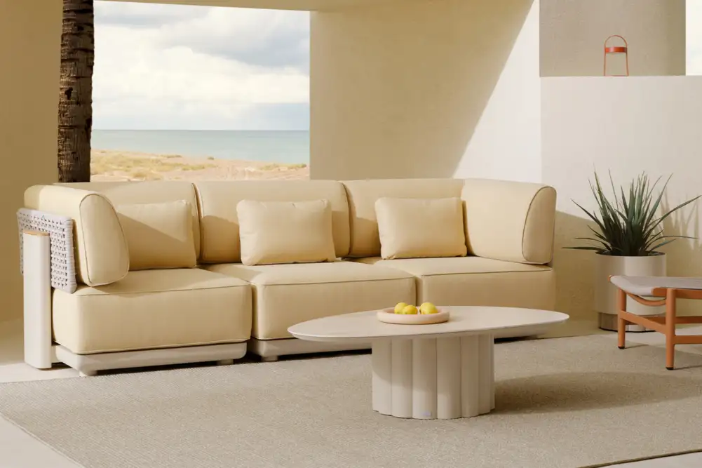 Elegant travertine-coloured fluted coffee table with a textured base and smooth top, ideal for outdoor spaces, blending modern design with natural tones